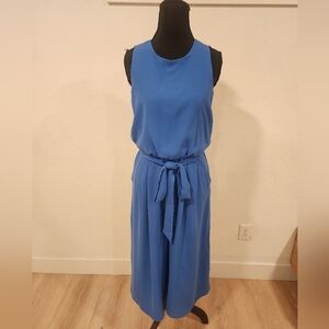 Vince Camuto sleeveless, wide-leg or cropped jumpsuit in a solid blue color.